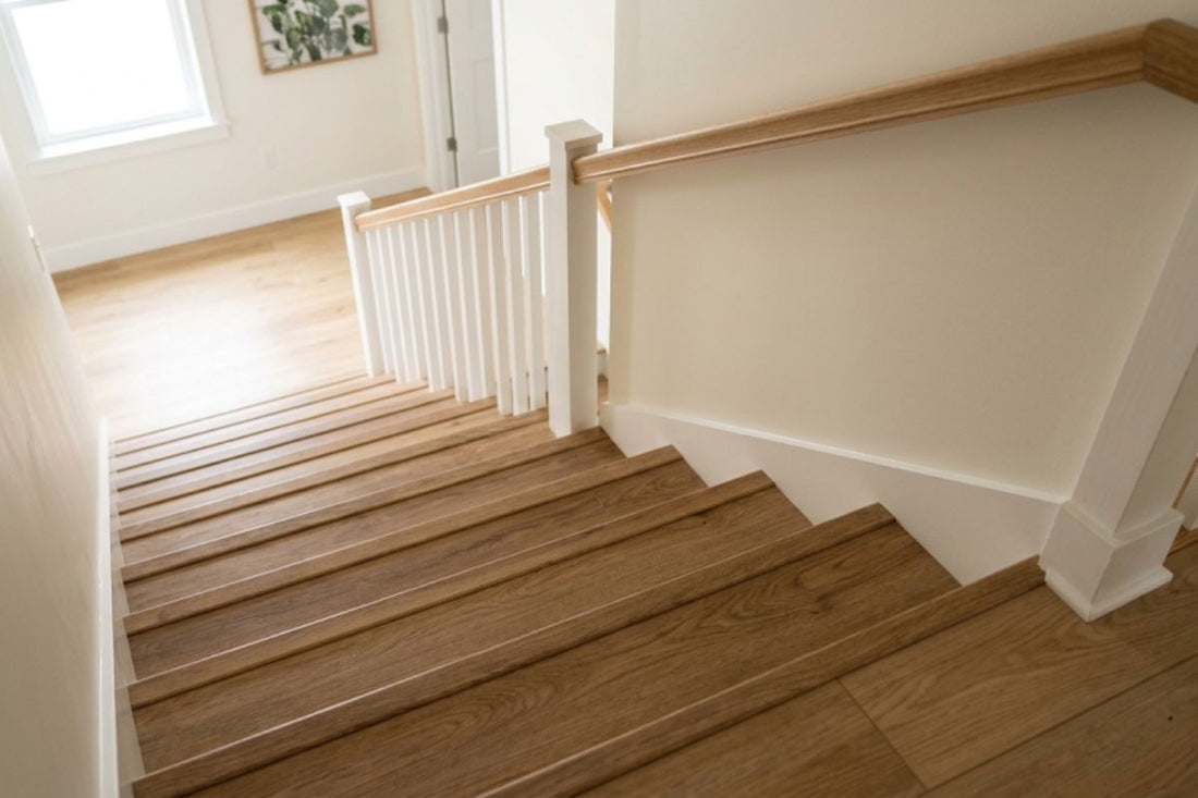 Residential staircase finished with wood look vinyl stair treads and matching risers